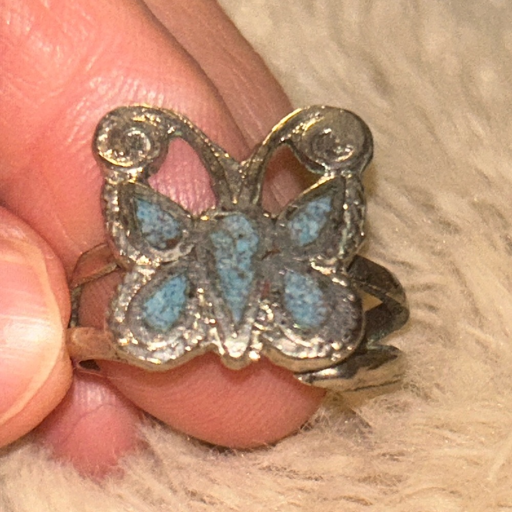 Silver colored butterfly ring with turquoise colored accents